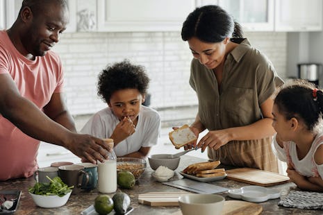 A family prepares breakfast in their kitchen.